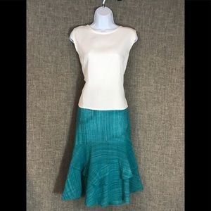 A white shell top with ruffle skirt, turquoise
